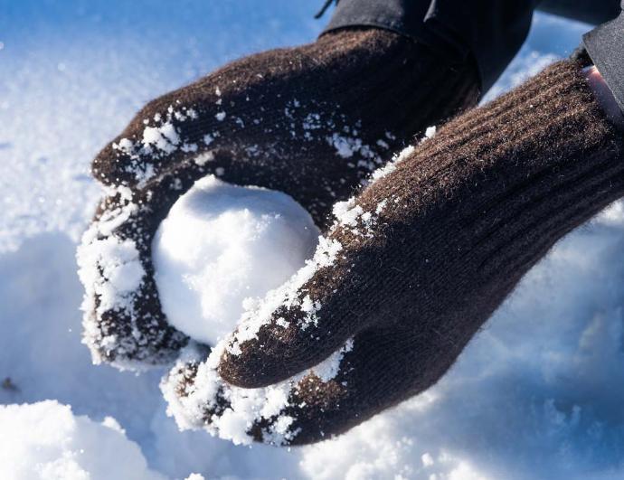 Wool mittens hold snowball