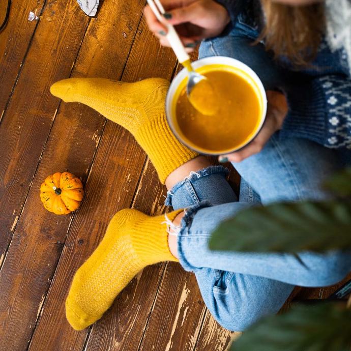Yellow woollen socks are worn when eating soup.